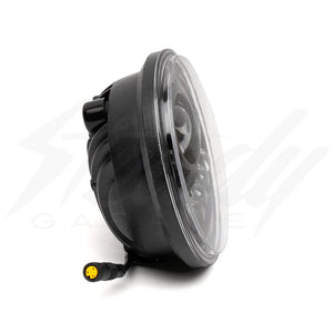 Front view of the Super73 R Brooklyn SE eBike featuring a mounted headlight illuminated in a dimly lit setting.