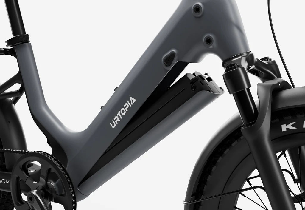 Side view of the Urtopia Carbon Joy eBike in charcoal gray, showcasing its sleek carbon fiber frame, integrated battery, and minimalist design against a plain background.