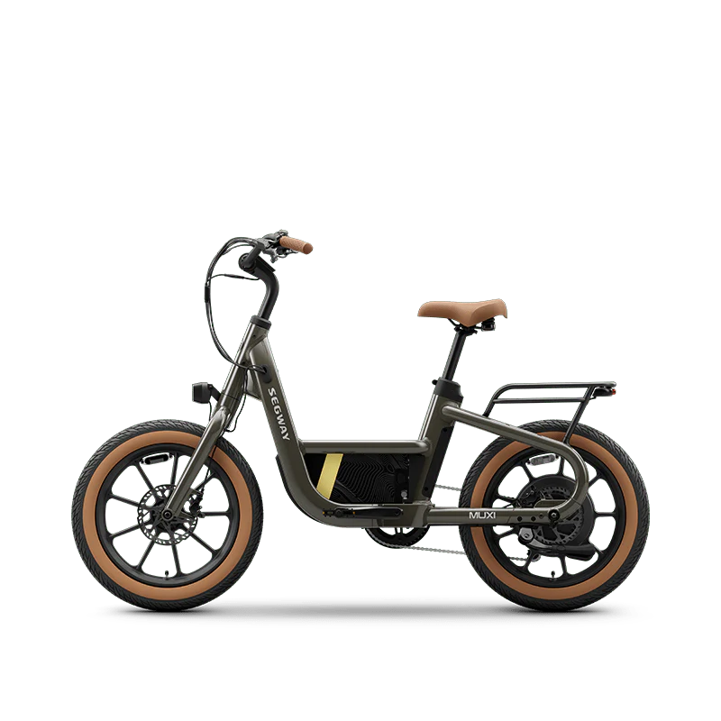 Olive green Segway Muxi eBike, side view, parked on a paved surface with a blurred outdoor background.