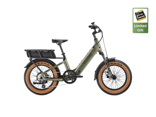 Velotric GoMad eBike in Sage color, side view, showing step-through frame, wide tires, and rear cargo rack.