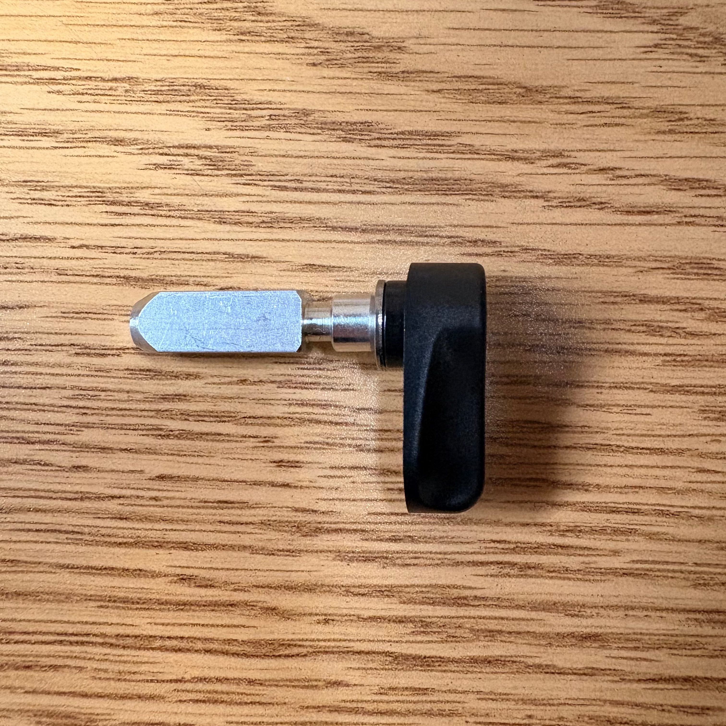 Close-up of the Mokwheel eBike battery release lever attached to the bike frame