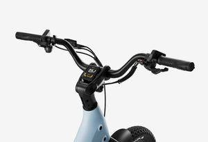 Side view of the Urtopia Carbon Joy Ultra eBike in Glacier Blue, showcasing its sleek carbon frame, integrated battery, and modern design against a white background.