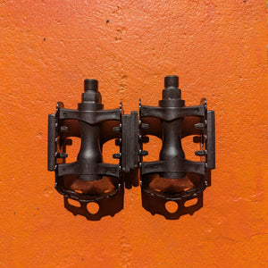 Close-up of metal e-bike pedals in a modern, rugged style, featuring a textured surface and durable construction.